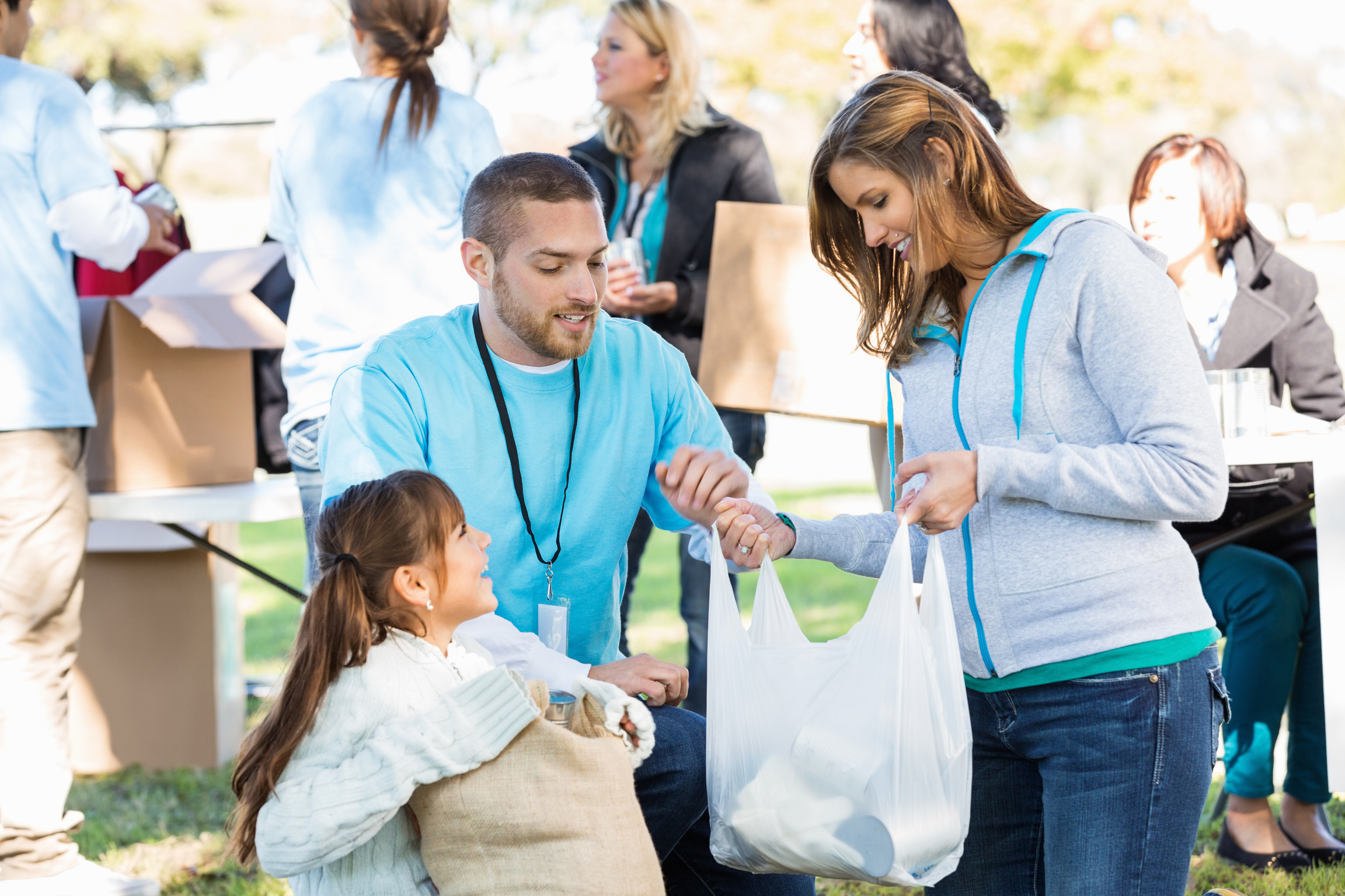 Mom and daughter donating food at donation drive