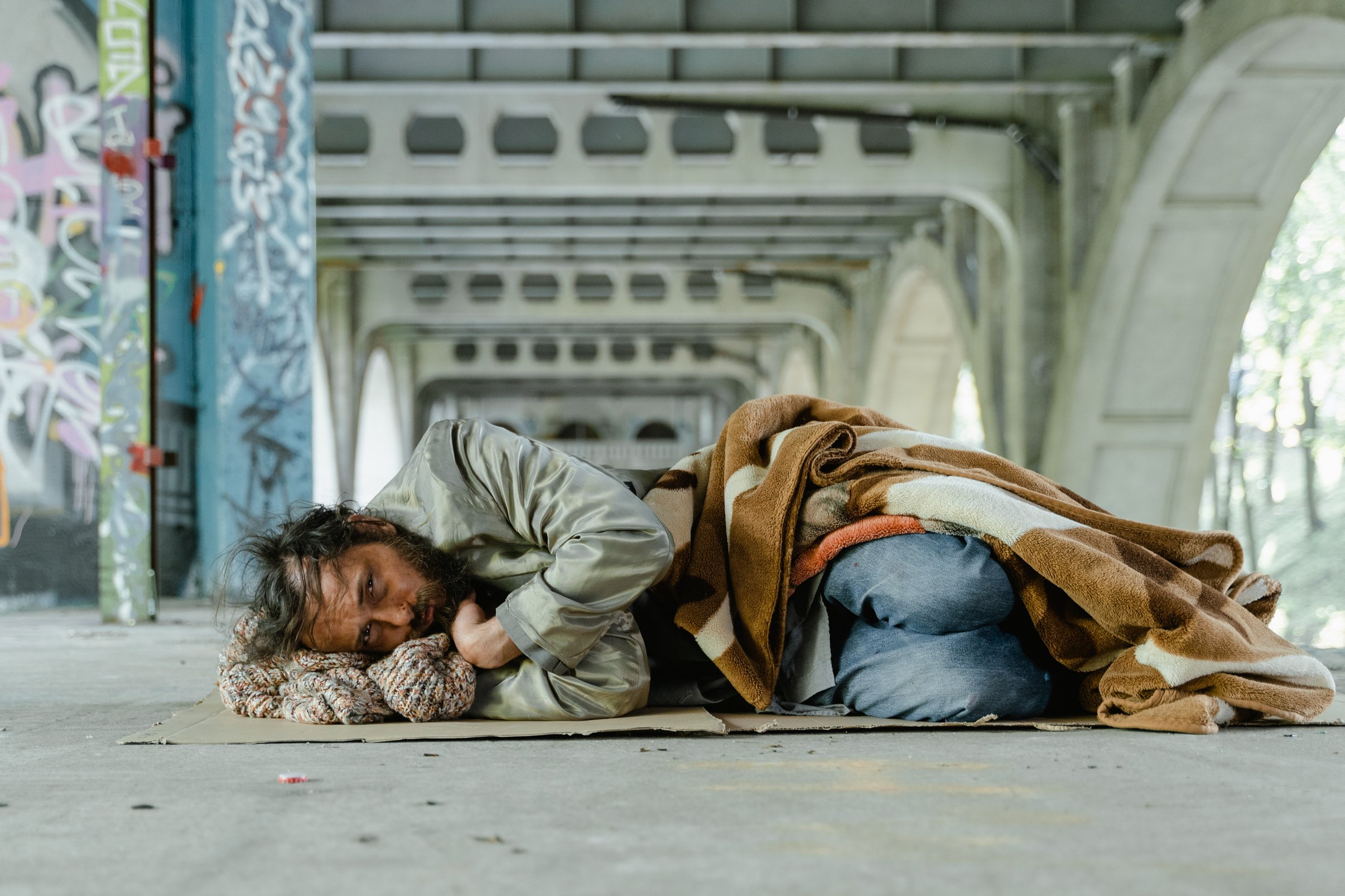 Man in Green Jacket Lying on Floor